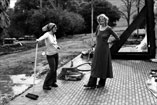 222-37 Nancy and Kathy cleaning adobe porch